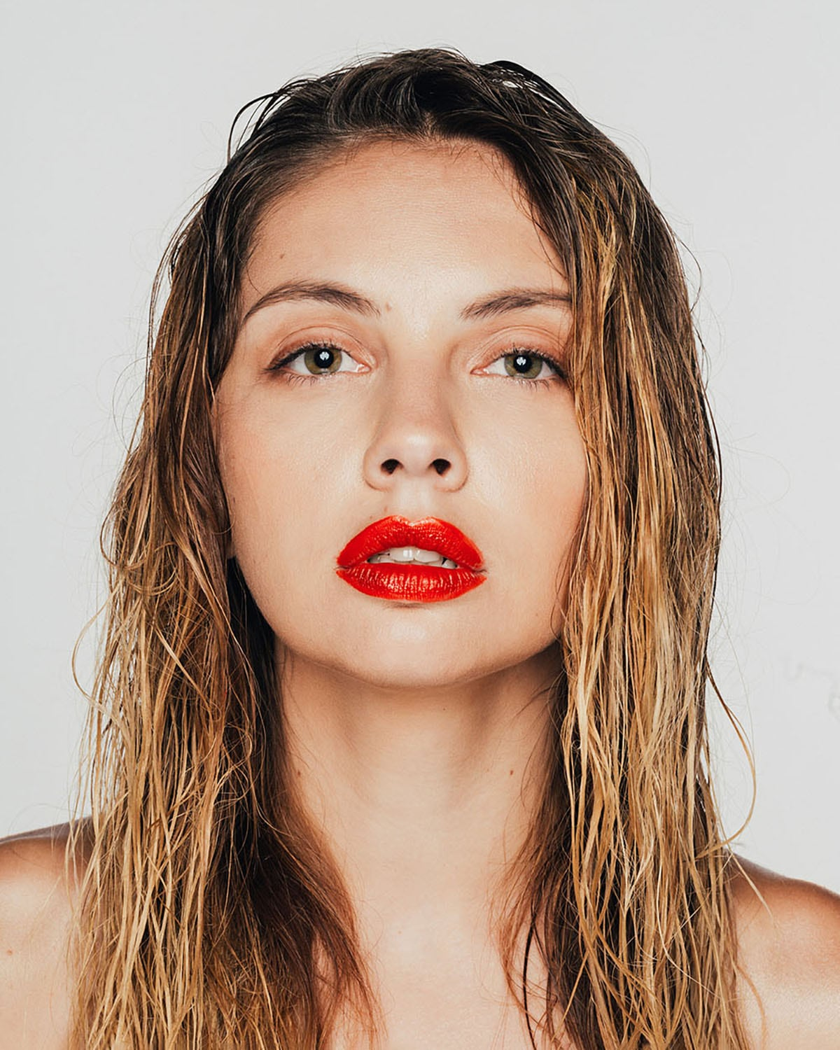 Striking portrait photography of gorgeous female model Inna Khimich with bright red lipstick detail shot in studio by London portrait photographer Ira Giorgetti